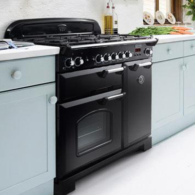 Black range cooker in a fresh aqua country-style kitchen